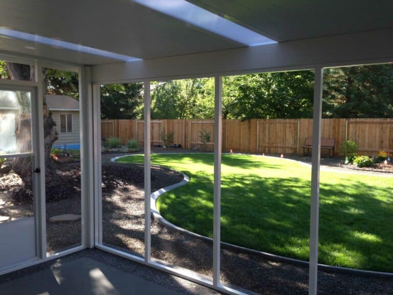 screen rooms installed near the garden Patio Covers Unlimited