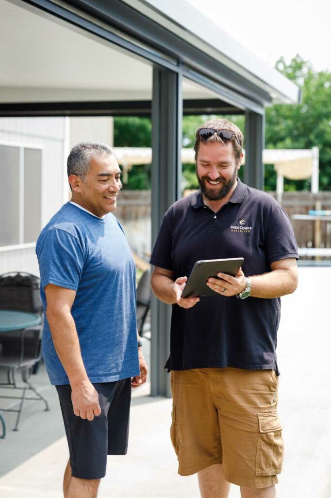 Patio Covers Unlimited showing the client a project in a ipad