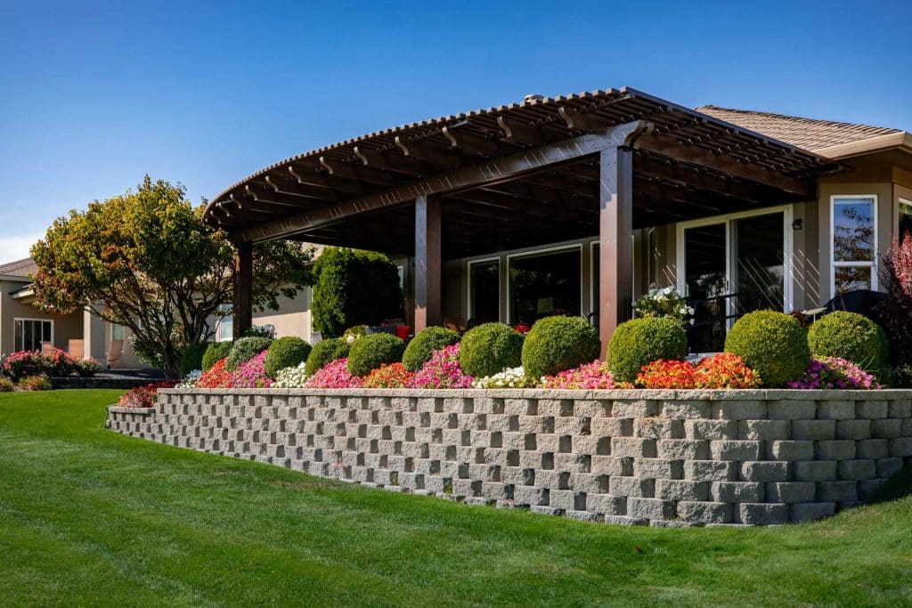 a beautiful custom patio cover surrounded with green plants